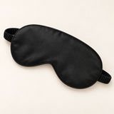 Hushly satin sleep mask in black on warm ivory