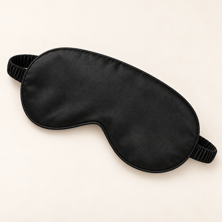 Hushly satin sleep mask in black on warm ivory